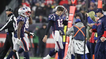FOXBOROUGH, MASSACHUSETTS - JANUARY 04: Tom Brady #12 of the New England Patriots reacts as he walks to the sideline as they take on the Tennessee Titans in the second half of the AFC Wild Card Playoff game at Gillette Stadium on January 04, 2020 in Foxborough, Massachusetts. (Photo by Elsa/Getty Images)