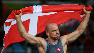 RIO DE JANEIRO, BRAZIL - AUGUST 14, 2016: Mark Overgaard Madsen of Denmark waving his national flag after winning silver in the men's -75kg wrestling final at the Rio 2016 Summer Olympic Games, at Carioca Arena 2. Valery Sharifulin/TASS (Photo by Valery SharifulinTASS via Getty Images)