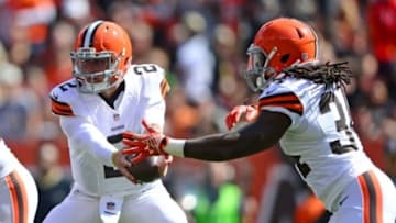 Sep 14, 2014; Cleveland, OH, USA; Cleveland Browns quarterback Johnny Manziel (2) hands the ball of to running back Isaiah Crowell (34) during the third quarter against the New Orleans Saints at FirstEnergy Stadium. Mandatory Credit: Andrew Weber-USA TODAY Sports