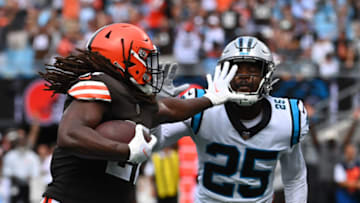 Sep 11, 2022; Charlotte, North Carolina, USA; Carolina Panthers safety Marquise Blair (27) runs for a touchdown as Carolina Panthers Xavier Woods (25) defends in the second quarter at Bank of America Stadium. Mandatory Credit: Bob Donnan-USA TODAY Sports