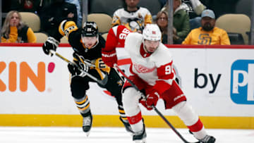 Oct 4, 2023; Pittsburgh, Pennsylvania, USA; Detroit Red Wings defenseman Jake Walman (96) skates up the ice with the puck ahead of Pittsburgh Penguins left wing Austin Wagner (25) during the third period at PPG Paints Arena. Detroit won 2-1. Mandatory Credit: Charles LeClaire-USA TODAY Sports