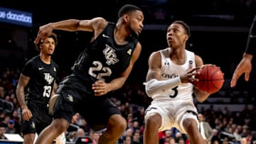UCF Knights Darin Green defends Cincinnati Bearcats guard Mika Adams-Woods at Fifth Third Arena. Getty Images.
