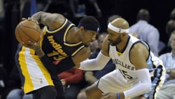 Apr 15, 2015; Memphis, TN, USA; Indiana Pacers forward Paul George (13) handles the ball against Memphis Grizzlies guard Vince Carter (15) during the game at FedExForum. Memphis Grizzlies beat Indiana Pacers 95-83 Mandatory Credit: Justin Ford-USA TODAY Sports