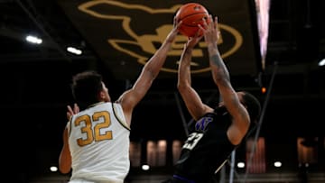 Jan 9, 2022; Boulder, Colorado, USA; Colorado Buffaloes guard Nique Clifford (32) blocks the shot of Washington Huskies guard Terrell Brown Jr. (23) in the second half at the CU Events Center. Mandatory Credit: Ron Chenoy-USA TODAY Sports