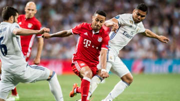 MADRID, SPAIN - APRIL 18: Thiago (c) of FC Bayern Munich battles for the ball with Carlos Henrique Casemiro (r) and Nacho Fernandez of Real Madrid during their 2016-17 UEFA Champions League Quarter-finals second leg match between Real Madrid and FC Bayern Munich at the Estadio Santiago Bernabeu on 18 April 2017 in Madrid, Spain. (Photo by Power Sport Images/Getty Images)