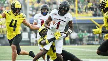 Sep 10, 2022; Eugene, Oregon, USA; Oregon Ducks defensive back Dontae Manning (8) tackles Eastern Washington Eagles wide receiver Freddie Roberson (1) during the first half at Autzen Stadium. Mandatory Credit: Troy Wayrynen-USA TODAY Sports