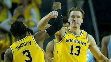 ANN ARBOR, MI - NOVEMBER 28: Ignas Brazdeikis #13 and Zavier Simpson #3 of the Michigan Wolverines celebrate a three point play during the second half of the game against the North Carolina Tar Heels at Crisler Center on November 28, 2018 in Ann Arbor, Michigan. Michigan defeated North Carolina Tar Heels 84-67. (Photo by Leon Halip/Getty Images)