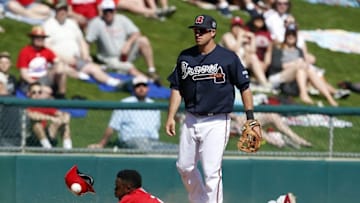 Mar 11, 2016; Lake Buena Vista, FL, USA; Philadelphia Phillies center fielder Roman Quinn (71) slides safely into third base as an errant throw to Atlanta Braves third baseman Sean Kasmar (92) goes by during the fifth inning at Champion Stadium. Mandatory Credit: Butch Dill-USA TODAY Sports