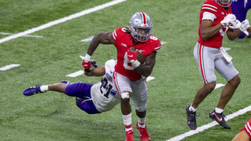 Dec 19, 2020; Indianapolis, Indiana, USA; Ohio State Buckeyes running back Trey Sermon (8) runs the ball against Northwestern Wildcats defensive back Cameron Mitchell (21) during the second half of a Big Ten Championship game at Lucas Oil Stadium. Mandatory Credit: Doug McSchooler-USA TODAY Sports