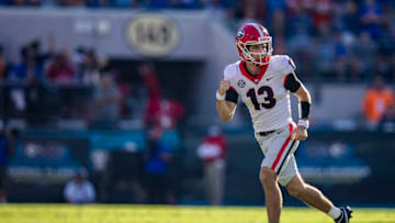 Stetson Bennett #13 of the Georgia Bulldogs celebrates after scoring a touchdown during the second quarter of a game against the Florida Gators at TIAA Bank Field on October 30, 2021 in Jacksonville, Florida. (Photo by James Gilbert/Getty Images)