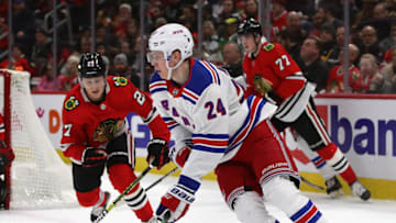 CHICAGO, ILLINOIS - FEBRUARY 19: Kaapo Kakko #24 of the New York Rangers controls the puck as Adam Boqvist #27 of the Chicago Blackhawks closes in at the United Center on February 19, 2020 in Chicago, Illinois. (Photo by Jonathan Daniel/Getty Images)