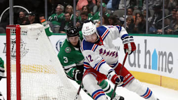 DALLAS, TEXAS - MARCH 10: Julien Gauthier #12 of the New York Rangers skates the puck against John Klingberg #3 of the Dallas Stars during the second period at American Airlines Center on March 10, 2020 in Dallas, Texas. (Photo by Ronald Martinez/Getty Images)