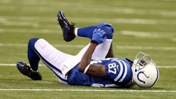 Oct 20, 2013; Indianapolis, IN, USA; Indianapolis Colts wide receiver Reggie Wayne (87) reacts after sustaining an injury against the Denver Broncos in the 2nd half during the game at Lucas Oil Stadium. Mandatory Credit: Brian Spurlock-USA TODAY Sports