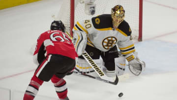Jan 9, 2016; Ottawa, Ontario, CAN; Boston Bruins goalie Tuukka Rask (40) makes a save against Ottawa Senators defenseman Erik Karlsson (65) in overtime at the Canadian Tire Centre. The Senators won 2-1 in overtime. Mandatory Credit: Marc DesRosiers-USA TODAY Sports