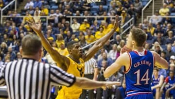 Jan 12, 2016; Morgantown, WV, USA; West Virginia Mountaineers forward Jonathan Holton (1) pressures Kansas Jayhawks guard Brannen Greene (14) during the first half at the WVU Coliseum. Mandatory Credit: Ben Queen-USA TODAY Sports