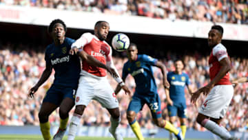 LONDON, ENGLAND - AUGUST 25: Alexandre Lacazette of Arsenal is challenged by Carlos Sanchez of West Ham United during the Premier League match between Arsenal FC and West Ham United at Emirates Stadium on August 25, 2018 in London, United Kingdom. (Photo by Clive Mason/Getty Images)