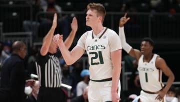Jan 18, 2022; Coral Gables, Florida, USA; Miami Hurricanes forward Sam Waardenburg (21) reacts after making a three point shot against the North Carolina Tar Heels during the first half at Watsco Center. Mandatory Credit: Jasen Vinlove-USA TODAY Sports