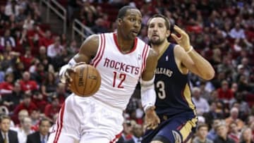 Dec 28, 2013; Houston, TX, USA; Houston Rockets power forward Dwight Howard (12) drives the ball around New Orleans Pelicans power forward Ryan Anderson (33) during the third quarter at Toyota Center. Mandatory Credit: Troy Taormina-USA TODAY Sports