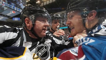 DENVER, CO - MARCH 28: Linesman Lonnie Cameron #74 holds back Gabriel Landeskog #92 of the Colorado Avalanche as he tries to fight Tim Schaller #59 of the Buffalo Sabres at the Pepsi Center on March 28, 2015 in Denver, Colorado. (Photo by Michael Martin/NHLI via Getty Images)