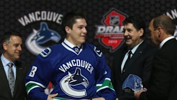 NEWARK, NJ - JUNE 30: Bo Horvat (C) poses with Laurence Gilman (L), Vice President Hockey Operations and Assistant General Manager, and Ron Delorme (R), Chief Amateur Scout after being selected number nine overall in the first round by the Vancouver Canucks during the 2013 NHL Draft at the Prudential Center on June 30, 2013 in Newark, New Jersey. (Photo by Bruce Bennett/Getty Images)