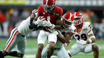 Alabama Crimson Tide wide receiver Jameson Williams (1) is brought down by a slew of Georgia Bulldogs defenders Monday, Jan. 10, 2022, during the College Football Playoff National Championship at Lucas Oil Stadium in Indianapolis.