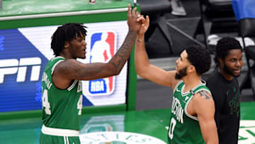 BOSTON, MASSACHUSETTS - DECEMBER 23: Jayson Tatum #0 and Robert Williams III #44 of the Boston Celtics celebrate after defeating the Milwaukee Bucks at TD Garden on December 23, 2020 in Boston, Massachusetts. NOTE TO USER: User expressly acknowledges and agrees that, by downloading and/or using this photograph, user is consenting to the terms and conditions of the Getty Images License Agreement. (Photo by Brian Fluharty-Pool/Getty Images)