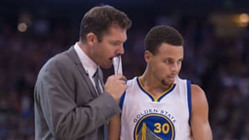 November 4, 2015; Oakland, CA, USA; Golden State Warriors interim head coach Luke Walton (left) talks to guard Stephen Curry (30) during the fourth quarter against the Los Angeles Clippers at Oracle Arena. The Warriors defeated the Clippers 112-108. Mandatory Credit: Kyle Terada-USA TODAY Sports