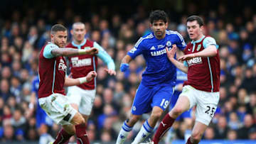 LONDON, ENGLAND - FEBRUARY 21: Diego Costa of Chelsea is tackled by Michael Kightly of Burnley and Michael Keane of Burnley during the Barclays Premier League match between Chelsea and Burnley at Stamford Bridge on February 21, 2015 in London, England. (Photo by Paul Gilham/Getty Images)