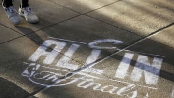 Jun 16, 2015; Cleveland, OH, USA; Fans walk about an "All In" logo before game six of the NBA Finals between the Golden State Warriors and the Cleveland Cavaliers at Quicken Loans Arena. Mandatory Credit: Peter Casey-USA TODAY Sports