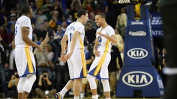 Feb 22, 2014; Oakland, CA, USA; Golden State Warriors point guard Stephen Curry (30) celebrates with shooting guard Klay Thompson (11) and small forward Andre Iguodala (9) after scoring a three point basket against the Brooklyn Nets during the fourth quarter at Oracle Arena. The Golden State Warriors defeated the Brooklyn Nets 93-86. Mandatory Credit: Kelley L Cox-USA TODAY Sports