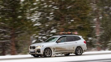 MT ROSE HIGHWAY, RENO, NEVADA, UNITED STATES - 2022/02/22: A car with skis on the roof drives along a snow-covered road despite the winter conditions.Winter road conditions worsen as snow falls in the mountains. Chains were required on all vehicles except 4-Wheel drive with snow tires. (Photo by Ty O'Neil/SOPA Images/LightRocket via Getty Images)