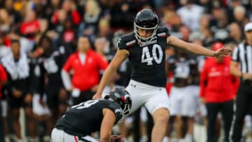 Cincinnati Bearcats place kicker Ryan Coe kicks field goal against Navy Midshipmen at Nippert Stadium. USA Today.