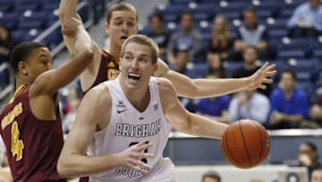 Dec 18, 2015; Provo, UT, USA; Brigham Young Cougars forward Kyle Davis (21) dribbles the ball around Central Michigan Chippewas guard Rayshawn Simmons (4) and forward Luke Meyer (24) in the first quarter at Marriott Center. Mandatory Credit: Jeff Swinger-USA TODAY Sports