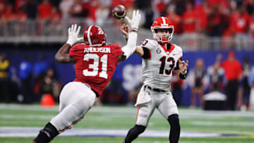 ATLANTA, GEORGIA - DECEMBER 04: Will Anderson Jr. #31 of the Alabama Crimson Tide pressures Stetson Bennett #13 of the Georgia Bulldogs into throwing an interception during the third quarter of the SEC Championship game against the at Mercedes-Benz Stadium on December 04, 2021 in Atlanta, Georgia. (Photo by Kevin C. Cox/Getty Images)