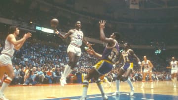 PHILADELPHIA, PA - CIRCA 1980: Darryl Dawkins #53 of the Philadelphia 76ers goes up to shoot over Magic Johnson #32 of the Los Angeles Lakers during an NBA basketball game circa 1980 at The Spectrum in Philadelphia, Pennsylvania. Dawkins played for the 76ers from 1975-82. (Photo by Focus on Sport/Getty Images)