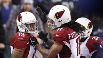 Dec 22, 2013; Seattle, WA, USA; Arizona Cardinals wide receiver Michael Floyd (15) is congratulated by Arizona Cardinals wide receiver Larry Fitzgerald (11) after catching a touchdown against the Seattle Seahawks during the fourth quarter at CenturyLink Field. Mandatory Credit: Joe Nicholson-USA TODAY Sports