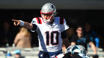 CHARLOTTE, NORTH CAROLINA - NOVEMBER 07: Mac Jones #10 of the New England Patriots calls a play at the line during the first quarter against the Carolina Panthers at Bank of America Stadium on November 07, 2021 in Charlotte, North Carolina. (Photo by Lance King/Getty Images)