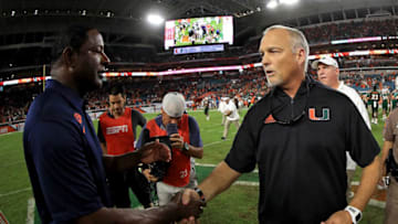 MIAMI GARDENS, FL - OCTOBER 21: Miami Hurricanes head coach Mark Richt shakes hands with Syracuse Orange head coach Dino Babers during a game at Sun Life Stadium on October 21, 2017 in Miami Gardens, Florida. (Photo by Mike Ehrmann/Getty Images)