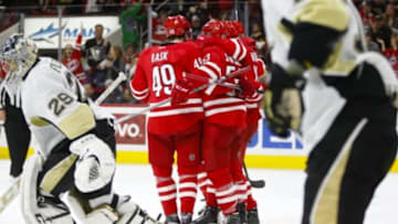 Jan 12, 2016; Raleigh, NC, USA; Carolina Hurricanes forward Jeff Skinner (53) is congratulated by his teammates Carolina Hurricanes forward Victor Rask (49) Carolina Hurricanes forward Elias Lindholm (16) after game winning overtime goal against the Pittsburgh Penguins at PNC Arena. The Carolina Hurricanes defeated the Pittsburgh Penguins 3-2 in overtime. Mandatory Credit: James Guillory-USA TODAY Sports
