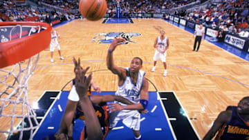 ORLANDO, FL - DECEMBER 19: Tracy McGrady #1 of the Orlando Magic shoots over Clifford Robinson #3 and Erick Dampier #25 of the Golden State Warriors during the NBA game at TD Waterhouse Centre on December 19, 2003 in Orlando, Florida. The Magic won 119-93. NOTE TO USER: User expressly acknowledges and agrees that, by downloading and/or using this Photograph, User is consenting to the terms and conditions of the Getty Images License Agreement. (Photo by Fernando Medina/NBAE via Getty Images)