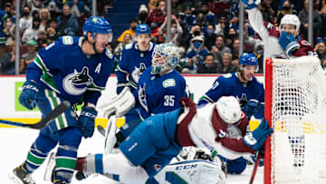 VANCOUVER, BC - NOVEMBER 17: Nazem Kadri #91 of the Colorado Avalanche is hit by J.T. Miller #9 of the Vancouver Canucks after scoring a goal on goalie Thatcher Demko #35 during the third period on November, 17, 2021 at Rogers Arena in Vancouver, British Columbia, Canada. Travis Hamonic #27 and Kyle Burroughs #44 of the Vancouver Canucks along with Gabriel Landeskog #92 of the Colorado Avalanche look on during the play. (Photo by Rich Lam/Getty Images)