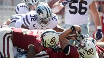 Sep 26, 2020; Norman, Oklahoma, USA; Oklahoma Sooners quarterback Spencer Rattler (7) is tackled by Kansas State Wildcats linebacker Justin Hughes (32) during the game at Gaylord Family Oklahoma Memorial Stadium. Mandatory Credit: Kevin Jairaj-USA TODAY Sports