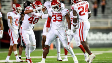 LUBBOCK, TEXAS - OCTOBER 31: Defensive end Marcus Stripling #33 of the Oklahoma Sooners reacts with linebackers Jon-Michael Terry #40 and Brian Asamoah #24 after making a tackle during the second half of the college football game against the Texas Tech Red Raiders at Jones AT&T Stadium on October 31, 2020 in Lubbock, Texas. (Photo by John E. Moore III/Getty Images)