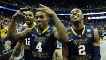 Mar 22, 2015; Columbus, OH, USA; West Virginia Mountaineers guard Tarik Phillip (12), guard Daxter Miles Jr. (4), and guard Jevon Carter (2) react after the game against the Maryland Terrapins in the third round of the 2015 NCAA Tournament at Nationwide Arena. West Virginia won 69-59. Mandatory Credit: Greg Bartram-USA TODAY Sports