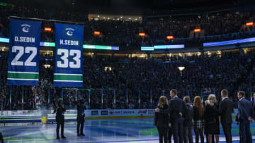 Feb 12, 2020; Vancouver, British Columbia, CAN; Twin brothers Daniel Sedin (22) and Henrik Sedin (33) of Sweden have their Vancouver Canucks jerseys retired to the rafters of Rogers Arena in a ceremony prior to a game between the Vancouver Canucks and Chicago Blackhawks. Mandatory Credit: Bob Frid-USA TODAY Sports