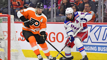 Apr 13, 2022; Philadelphia, Pennsylvania, USA; Philadelphia Flyers center Kevin Hayes (13) and New York Rangers center Mika Zibanejad (93) battle for the puck during the third period at Wells Fargo Center. Mandatory Credit: Eric Hartline-USA TODAY Sports