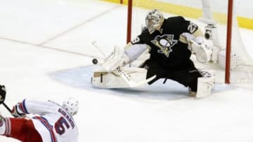 May 13, 2014; Pittsburgh, PA, USA; Pittsburgh Penguins goalie Marc-Andre Fleury (29) makes a save against New York Rangers defenseman Dan Girardi (5) during the second period in game seven of the second round of the 2014 Stanley Cup Playoffs at the CONSOL Energy Center. Mandatory Credit: Charles LeClaire-USA TODAY Sports