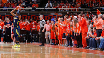 CHAMPAIGN, IL - MARCH 4: Illinois Fighting Illini fans from the Orange Krush try to distract Glenn Robinson III #1 of the Michigan Wolverines during the game at State Farm Center on March 4, 2014 in Champaign, Illinois. Michigan defeated Illinois 84-53. (Photo by Joe Robbins/Getty Images)
