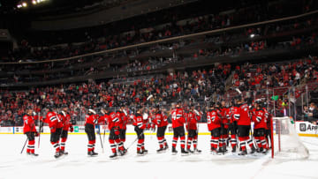 The New Jersey Devils celebrate their 5-3 victory over the Colorado Avalanche at the Prudential Center on March 08, 2022 in Newark, New Jersey. (Photo by Bruce Bennett/Getty Images)