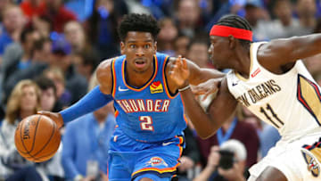 Week 3 NBA Power Rankings: Shai Gilgeous-Alexander of the OKC Thunder drives against Jrue Holiday. (Photo by Ron Jenkins/Getty Images)
